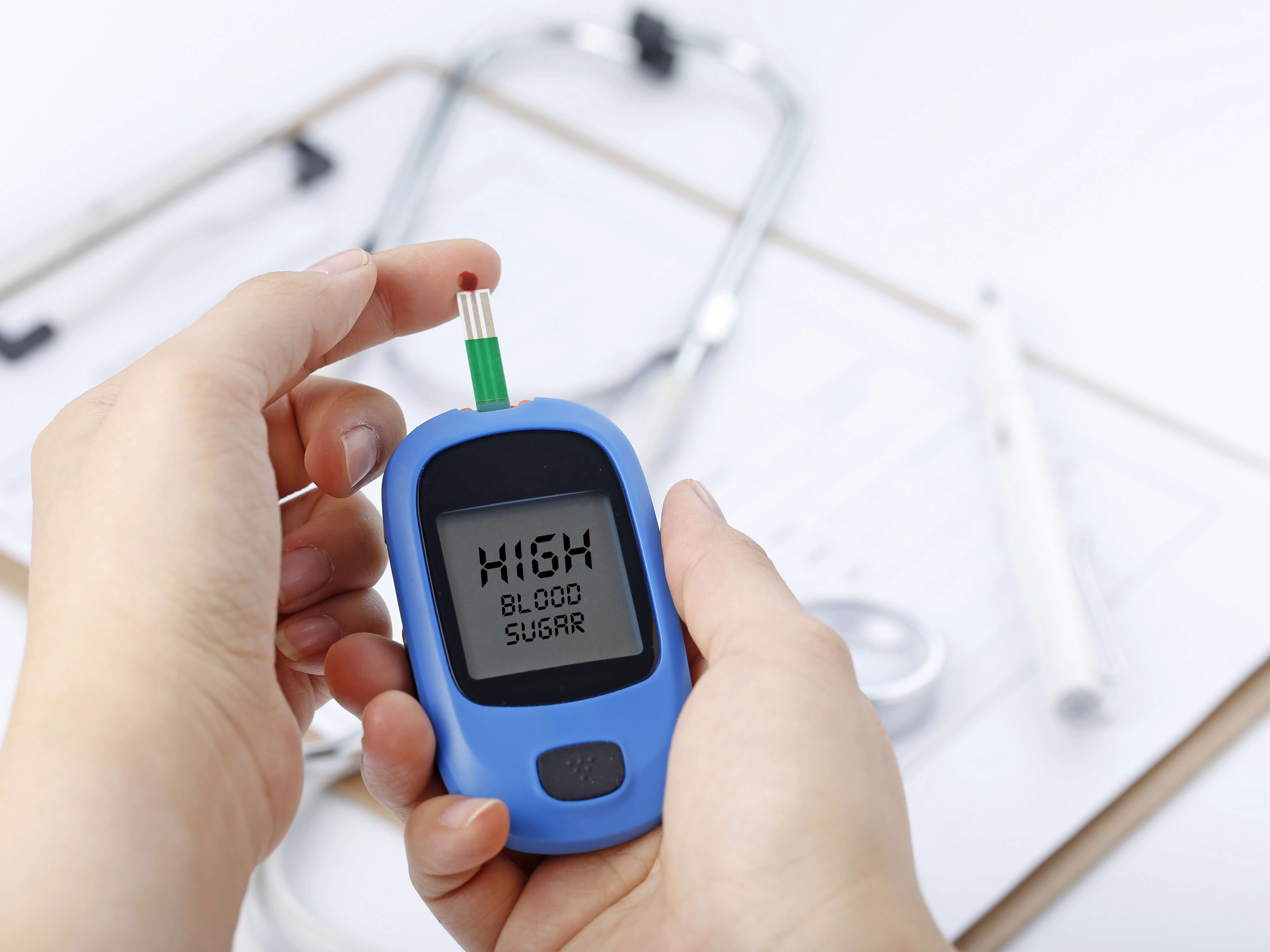 handholdingbloodglucosemetermeasuringbloodsugarbackgroundisstethoscopechartfile_u5mzk_4767