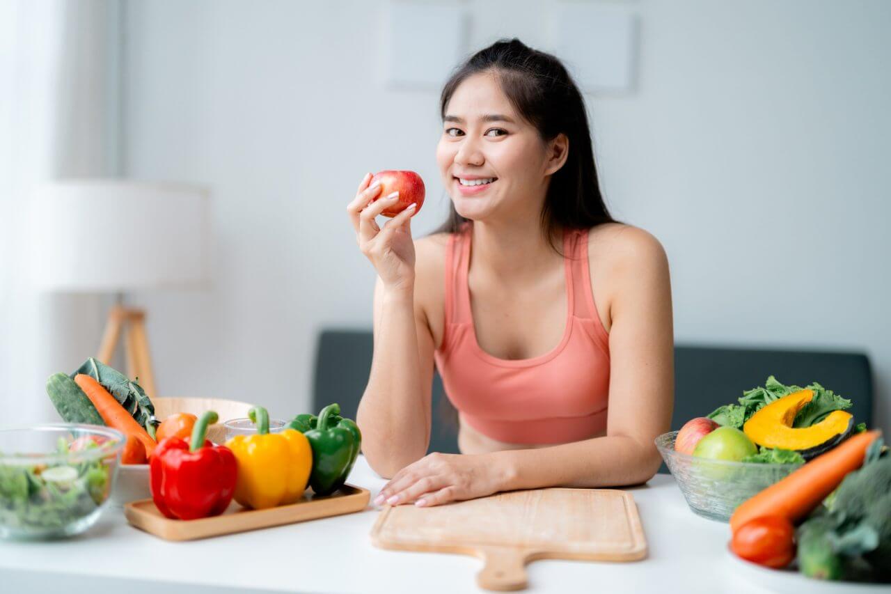happyyoungwomaneatinganapplepromotinghealthyeatinghabitsforawellnesslifestyle_e3njk_1280