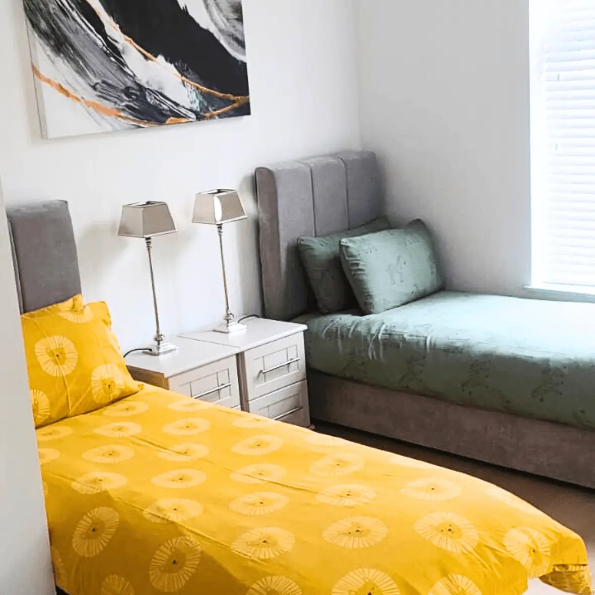 Twin bedroom with yellow throws