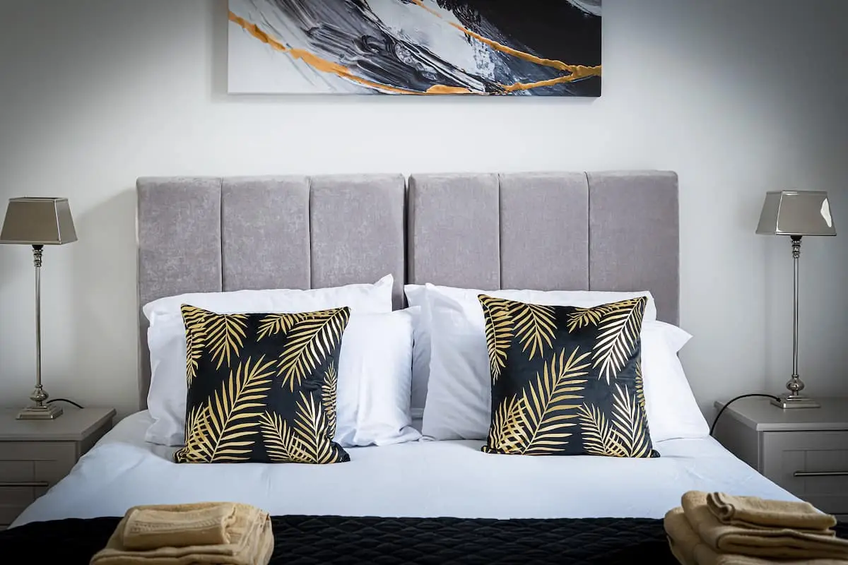 King bedroom with gold accent cushions