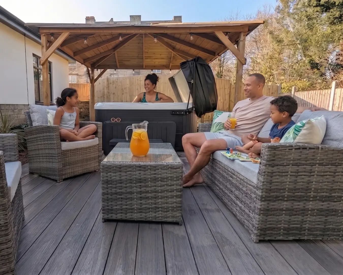 Family enjoying the hot tub and garden seating