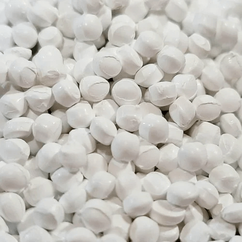 A heap of white plastic balls, known as White Masterbatch, used in various industries for coloring plastic products.