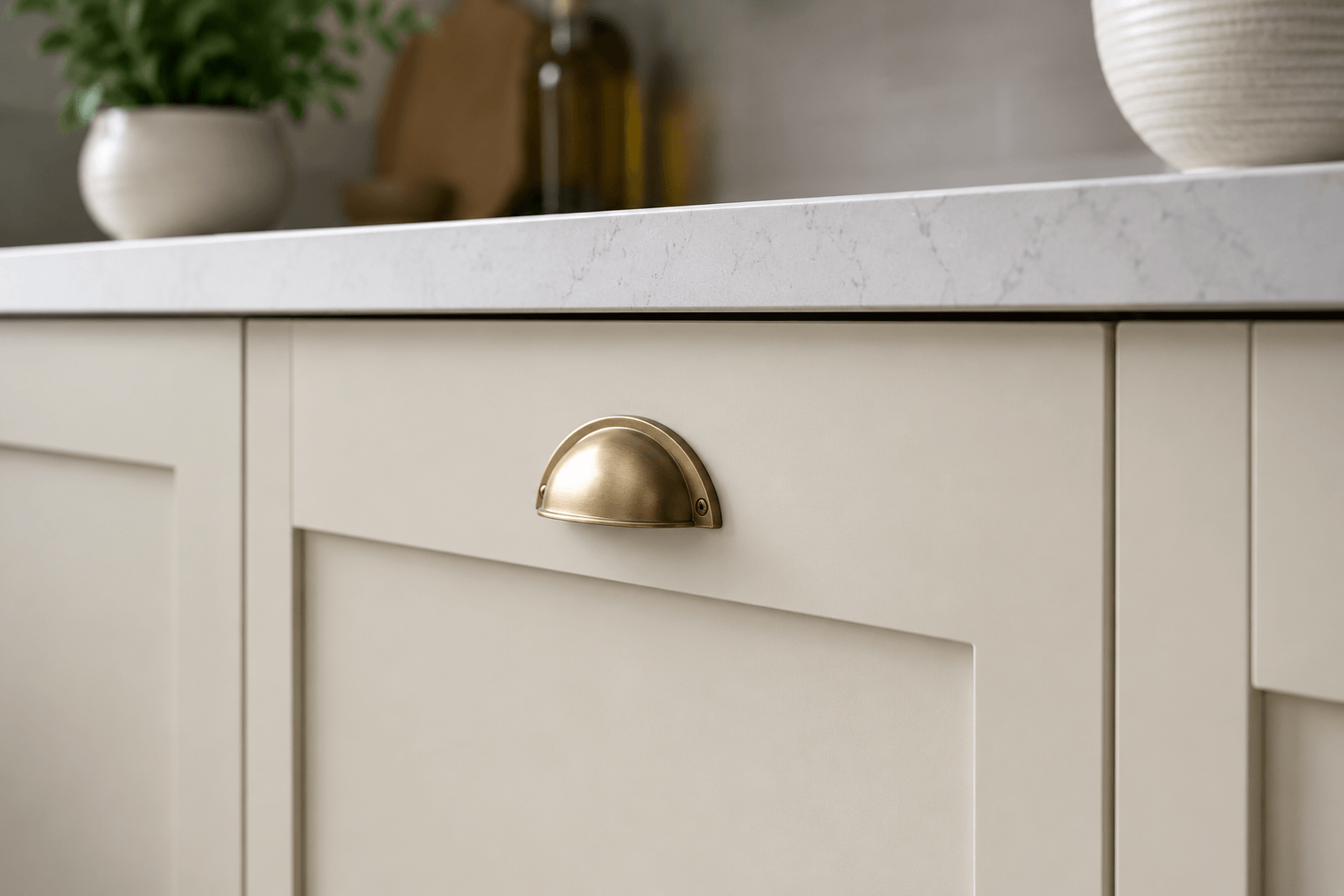 Close-up detail of replacement shaker kitchen door and brass cup handle
