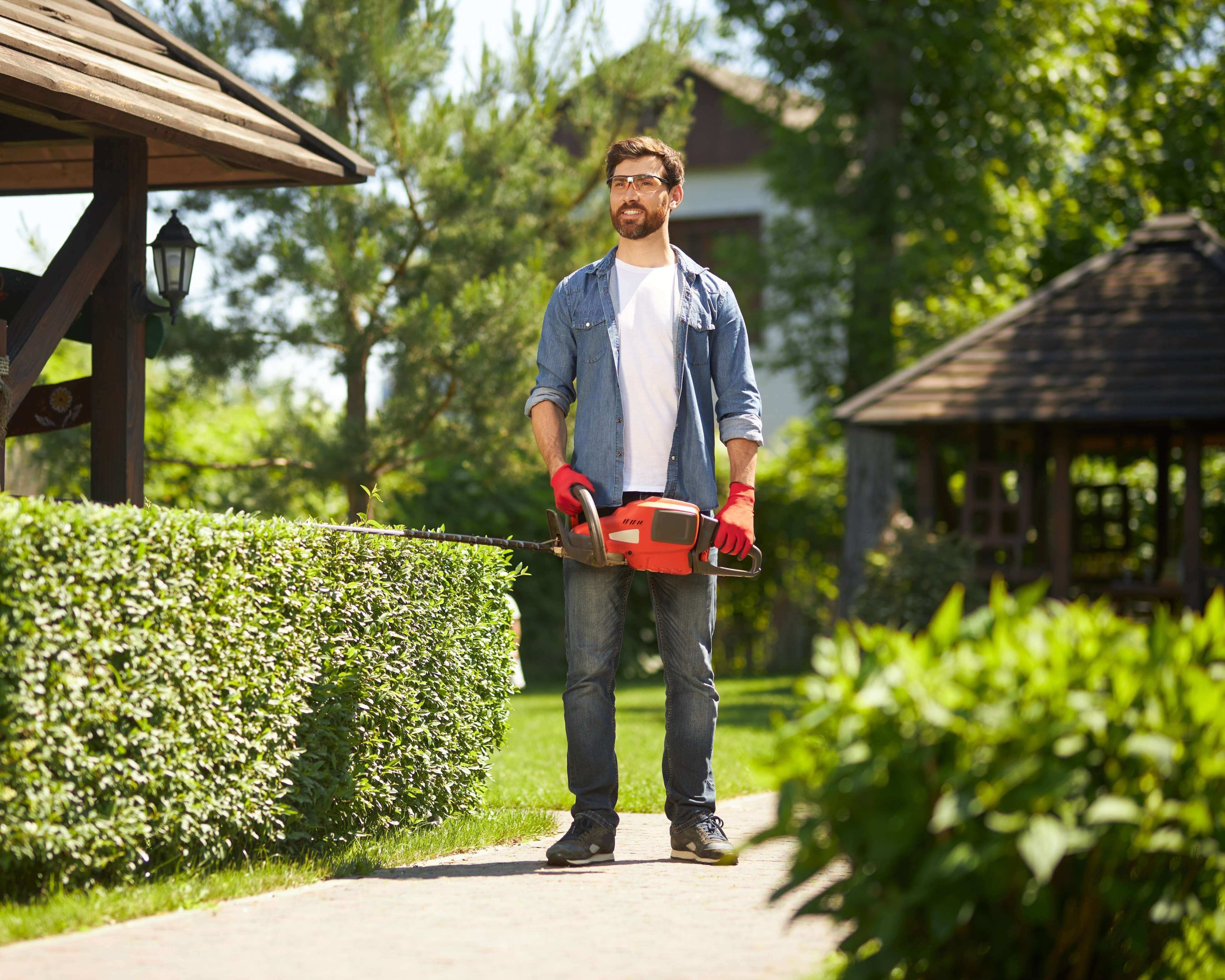happybeardedgardenerstandingcarryingmodernhandhedgetrimmerparklowangleview21_mxode_3919
